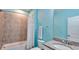 Bathroom featuring granite countertops, a shower-tub, and light-blue accent wall at 159 Captiva Dr, Davenport, FL 33896