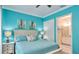 Light and airy bedroom featuring a serene blue color scheme and en-suite bathroom at 159 Captiva Dr, Davenport, FL 33896