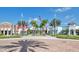 Community clubhouse featuring retail spaces with colorful facades and lush landscaping at 159 Captiva Dr, Davenport, FL 33896