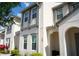Charming two-story home with white exterior, gray trim, manicured landscaping, and a welcoming front entrance at 159 Captiva Dr, Davenport, FL 33896