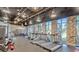Modern gym space with treadmills, weights, and exposed brick accent wall with bright lighting at 159 Captiva Dr, Davenport, FL 33896