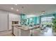 Open concept kitchen with stainless steel appliances, granite countertops, and bar seating at 159 Captiva Dr, Davenport, FL 33896