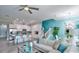 Open concept living room with stylish furnishings, modern lighting, and seamless flow to kitchen at 159 Captiva Dr, Davenport, FL 33896