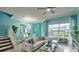 Bright living room with modern furnishings, ample natural light, and a view of the outdoors at 159 Captiva Dr, Davenport, FL 33896