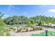 Community mini golf course surrounded by lush landscaping with a walking path and golf greens at 159 Captiva Dr, Davenport, FL 33896