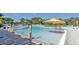 A large community pool with several lounge chairs and umbrellas at 159 Captiva Dr, Davenport, FL 33896