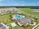 An aerial view of a community pool, clubhouse, playground, and parking area at 2073 Rock Maple Bnd, Kissimmee, FL 34746