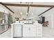 Charming kitchen showcasing a center island with seating, stainless steel appliances, and wood beam accents at 2440 Westwood Dr, Longwood, FL 32779