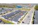 An aerial view of townhomes featuring private screened-in patios, and a community lake at 2636 Reading Trl, Kissimmee, FL 34746