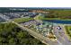 An aerial view showcases a community with a pool, clubhouse, lazy river, and lush landscaping at 2636 Reading Trl, Kissimmee, FL 34746