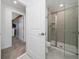 Modern bathroom featuring a glass-enclosed shower, neutral tiling, and sleek fixtures at 2636 Reading Trl, Kissimmee, FL 34746