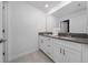 Well-lit bathroom features a double vanity, ample storage, and tiled flooring at 2636 Reading Trl, Kissimmee, FL 34746