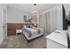 Modern bedroom featuring neutral tones, a decorative headboard, and elegant lighting at 2636 Reading Trl, Kissimmee, FL 34746