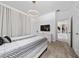 Modern bedroom with stylish lighting, a patterned bedspread, and access to an adjacent room at 2636 Reading Trl, Kissimmee, FL 34746