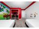Bright bedroom featuring a playful gaming-themed mural, two beds, and a built-in study nook at 2636 Reading Trl, Kissimmee, FL 34746