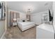 Comfortable bedroom with a large bed, modern lighting, and access to an ensuite bathroom at 2636 Reading Trl, Kissimmee, FL 34746