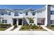 Stylish townhomes with modern architecture and landscaping with red doors at 2636 Reading Trl, Kissimmee, FL 34746
