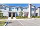 Modern townhomes with colorful doors, stone accents and lush landscaping, conveniently located near parking spaces at 2636 Reading Trl, Kissimmee, FL 34746