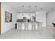 Bright, open kitchen featuring a gray countertop island with seating and pendant lighting at 2636 Reading Trl, Kissimmee, FL 34746