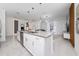 Open concept kitchen with island, stainless steel dishwasher and view of the living room at 2636 Reading Trl, Kissimmee, FL 34746