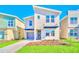 Beautiful two-story home featuring a modern design, well-kept lawn, and attached garage with stone accents at 2661 Petition Ln, Kissimmee, FL 34746