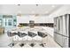 Bright, modern kitchen features stainless steel appliances, gray countertops, and barstool seating at the island at 2661 Petition Ln, Kissimmee, FL 34746