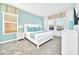 Serene main bedroom features light blue accent wall, white furnishings, and bright natural light at 2661 Petition Ln, Kissimmee, FL 34746