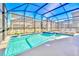 Screened in in-ground pool with integrated spa and lounge chairs, perfect for relaxing at 2661 Petition Ln, Kissimmee, FL 34746