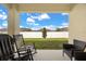 Inviting back porch with outdoor seating offering a view of the fenced backyard at 2706 Rowan St, Tavares, FL 32778