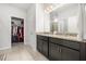 Bathroom with double vanity, granite countertops, walk-in closet and glass shower at 2706 Rowan St, Tavares, FL 32778