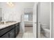 Well-lit bathroom showcasing granite countertops and an open doorway to the bedroom at 2706 Rowan St, Tavares, FL 32778