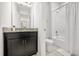 Bathroom featuring a granite vanity and a shower/bath combination with white tiling at 2706 Rowan St, Tavares, FL 32778