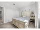 Airy bedroom features natural light, a decorative headboard, and simple, elegant furnishings that enhance the room's charm at 2706 Rowan St, Tavares, FL 32778