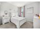 Inviting bedroom featuring chic décor, plush bedding, and neutral tones creating a relaxing and stylish retreat at 2706 Rowan St, Tavares, FL 32778