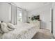 Comfortable bedroom with a soft, patterned comforter, large window with curtains, and serene decor elements at 2706 Rowan St, Tavares, FL 32778