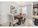 Elegant dining area featuring modern lighting, a wood table, and seating for six at 2706 Rowan St, Tavares, FL 32778
