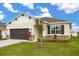 Beautiful single-story home with lush landscaping, a two-car garage, and stone accents at 2706 Rowan St, Tavares, FL 32778