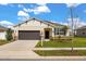 Charming single-story home featuring a well-manicured lawn, neutral paint, and a two-car garage at 2706 Rowan St, Tavares, FL 32778