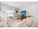 Bright and airy living room featuring neutral tones, tile flooring, and an entertainment center at 2706 Rowan St, Tavares, FL 32778