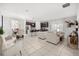 Open concept living and dining area with tile floors, stainless steel appliances, and modern design at 2706 Rowan St, Tavares, FL 32778