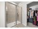 Bathroom showcasing a modern glass shower and view into the walk-in closet at 2706 Rowan St, Tavares, FL 32778
