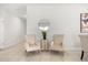 Cozy sitting area with comfortable chairs, neutral decor, and a decorative mirror at 2706 Rowan St, Tavares, FL 32778