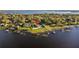 Waterfront home featuring a private dock, swimming pool, and expansive lawn at 2844 Marquesas Ct, Windermere, FL 34786