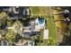 Aerial view of estate showing pool, beach volleyball court, personal dock, and lush landscaping at 2844 Marquesas Ct, Windermere, FL 34786
