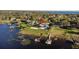 Beautiful waterfront property with expansive lawn, private pool, volleyball court, boat dock and gazebo offering luxurious outdoor living at 2844 Marquesas Ct, Windermere, FL 34786