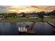 Waterfront property aerial view showcasing expansive lawn, luxurious pool area, and private dock offering serene lakefront lifestyle at 2844 Marquesas Ct, Windermere, FL 34786