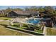 A luxury backyard featuring a modern pool, manicured lawn, and stylish outdoor seating creates an entertainer's dream space at 2844 Marquesas Ct, Windermere, FL 34786