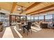 Bright dining room with beamed wood ceiling, ceiling fans, and large windows overlooking the water at 2844 Marquesas Ct, Windermere, FL 34786