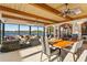 Open dining area with a view of the lake and outdoor seating through large glass windows and doors at 2844 Marquesas Ct, Windermere, FL 34786