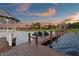 Waterfront vista featuring private wooden dock and gazebo, perfect for enjoying the lakefront lifestyle and sunset views at 2844 Marquesas Ct, Windermere, FL 34786